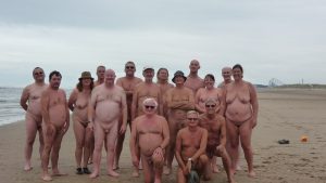 Group of naked people on beach